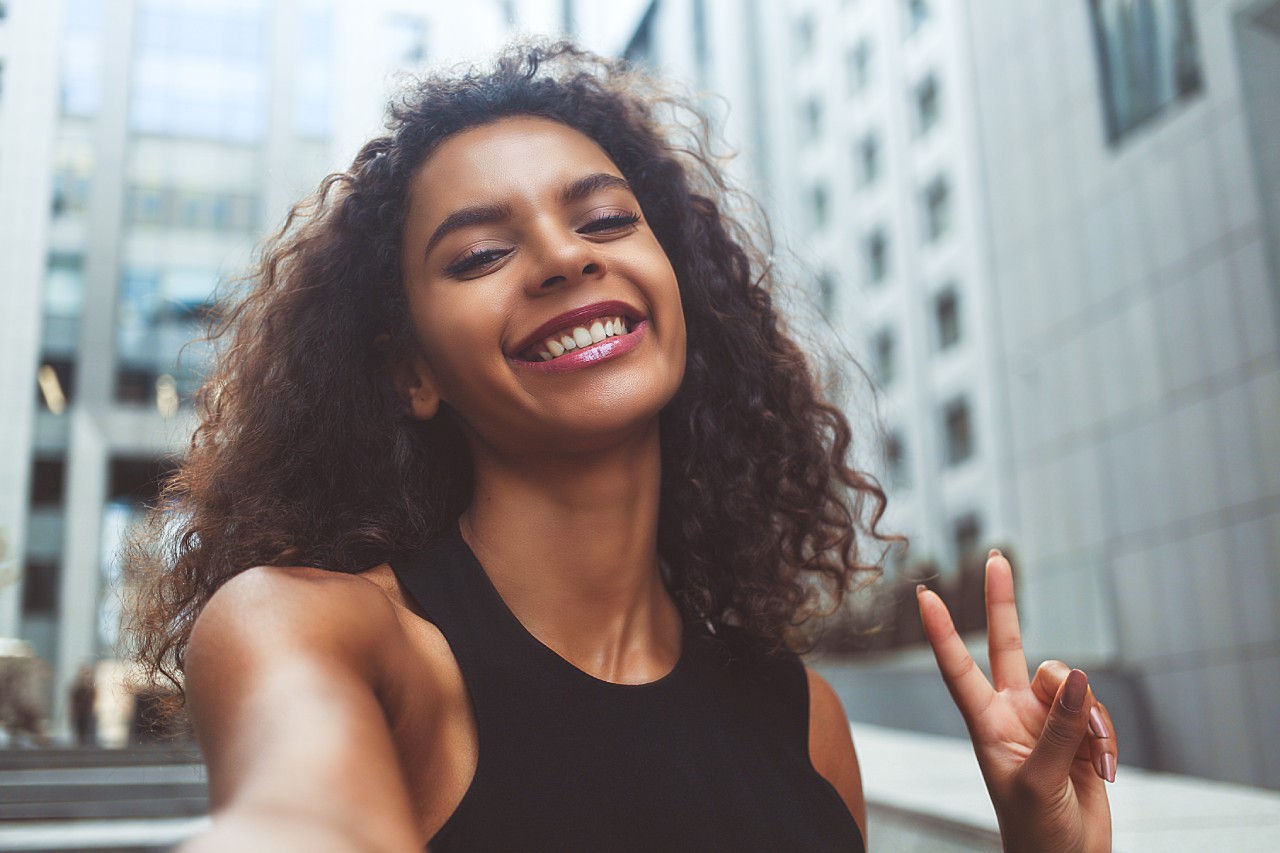 Mulher com um sorriso de cinema graças à sua saúde bucal impecável Mulher com um sorriso de cinema graças à sua saúde bucal impecável